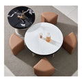 Overhead view of round coffee table, brown stools and black-top side table