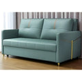 Teal sofa bed with gold-coloured trim beside a window