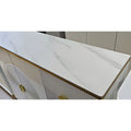 White stone-patterned shoe cabinet top with gold-coloured trim, close-up