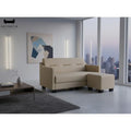 Beige faux leather sofa and ottoman beside a window