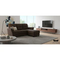 Dark brown faux leather sofa and ottoman in a living room
