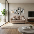 Beige Kova sofa against a wall with framed pictures