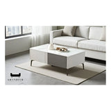 Two-tone grey coffee table with white top beside a light sofa
