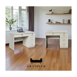 Two whitewashed desks with drawers beside a window