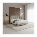Beige upholstered bed with panelled headboard in a bedroom