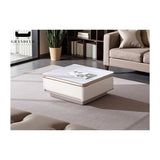 Square white-top coffee table with pale sides beside a sofa