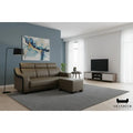 Brown sofa and ottoman beside a floor lamp