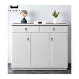 Glossy white shoe cabinet with upper drawers and small metallic knobs