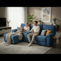 Two people seated on blue Montre sofa with central console