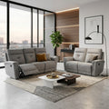 Grey Cove recliner sofa set with contrasting cushions beside a window