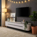 White Monarc TV console beneath a television in a dark room