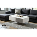 Two-tone grey coffee table with white top beside a dark sofa