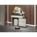 Pale dressing table with illuminated cloud-shaped mirror beside a stool