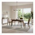 Wood dining table and chairs beneath a pendant light