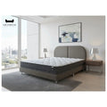 Dreamster Cosmos mattress and grey bed frame in a bright bedroom