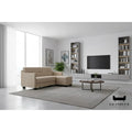 Beige faux leather sofa and ottoman in a bright living room