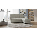 Light grey faux leather sofa and ottoman in a living room