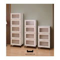 White storage chests with inset drawer fronts in three heights