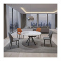 Round white dining table and grey chairs in an apartment