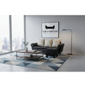 Black sofa and ottoman in a bright living room