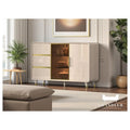 Light khaki side cabinet with gold-coloured drawer trim in a living room