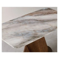 Grey veined dining tabletop and wood pedestal, close-up