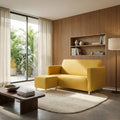 Yellow Lina sofa and ottoman beside a round rug