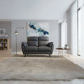 Dark grey padded armchair in a living room