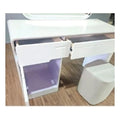 White dressing table with two shallow drawers pulled open