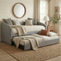 Grey Estelle daybed with trundle extended beneath a round mirror