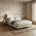 Beige upholstered bed in a softly lit bedroom