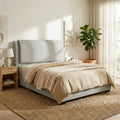Light grey Vionne bed in a sunlit bedroom