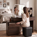 Person seated at walnut-look Isabelle dressing table with drawer open