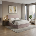 Pink upholstered bed beside a window