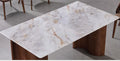 Pale veined dining tabletop with brown wooden supports, close-up
