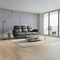 Dark grey three-seater sofa with padded backrest in a room