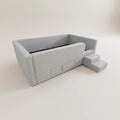 Grey enclosed daybed frame with access steps, angled view
