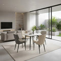 Square white dining table with grey chairs beside full-height windows